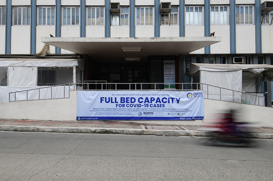 A sign saying full bed capacity for COVID-19 cases hangs in front of the Capitol Medical Center in Quezon City on August 29, 2021. 