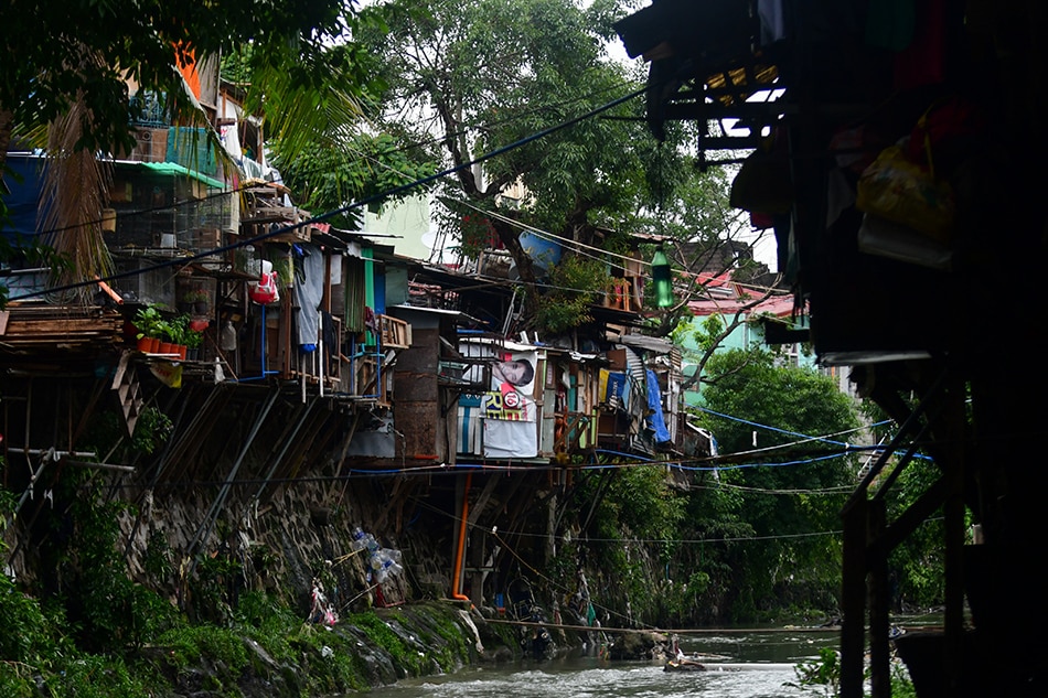 A line cordons off a side of K-6th Street in Quezon City on August 8, 2020, where a number of shanties collapsed to the creek and left a senior citizen dead due to heavy rainfall and sudden rise in the creek's water level the previous day. 