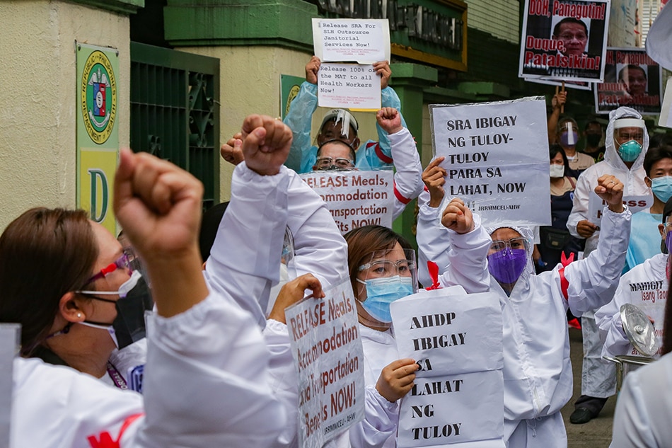 Health workers from different hospitals gather in front of the Department of Health headquarters in Sta. Cruz, Manila on Wednesday. 