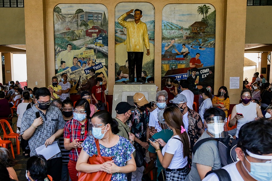 People prepare to exit the observation area after receiving their second dose of Moderna’s COVID-19 vaccine inside the Ramon Magsaysay High School in Manila on Sept. 4, 2021. George Calvelo, ABS-CBN News/File