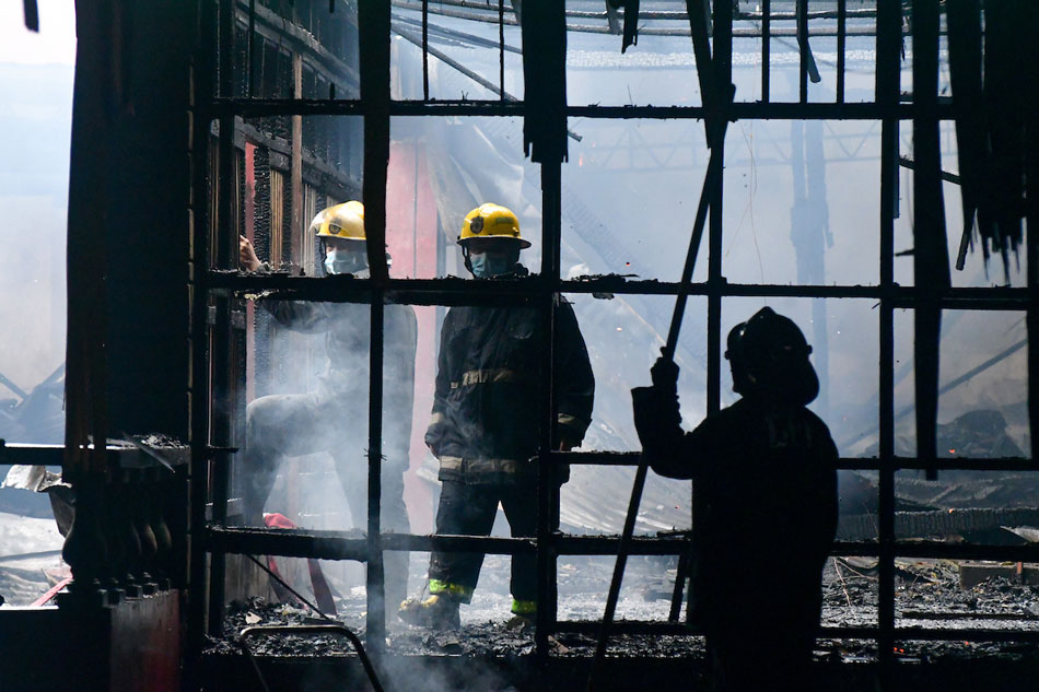 Firefighters douse a fire in a residential area in Brgy. South Triangle in Quezon City on Jan. 24, 2021. Mark Demayo, ABS-CBN News/File 