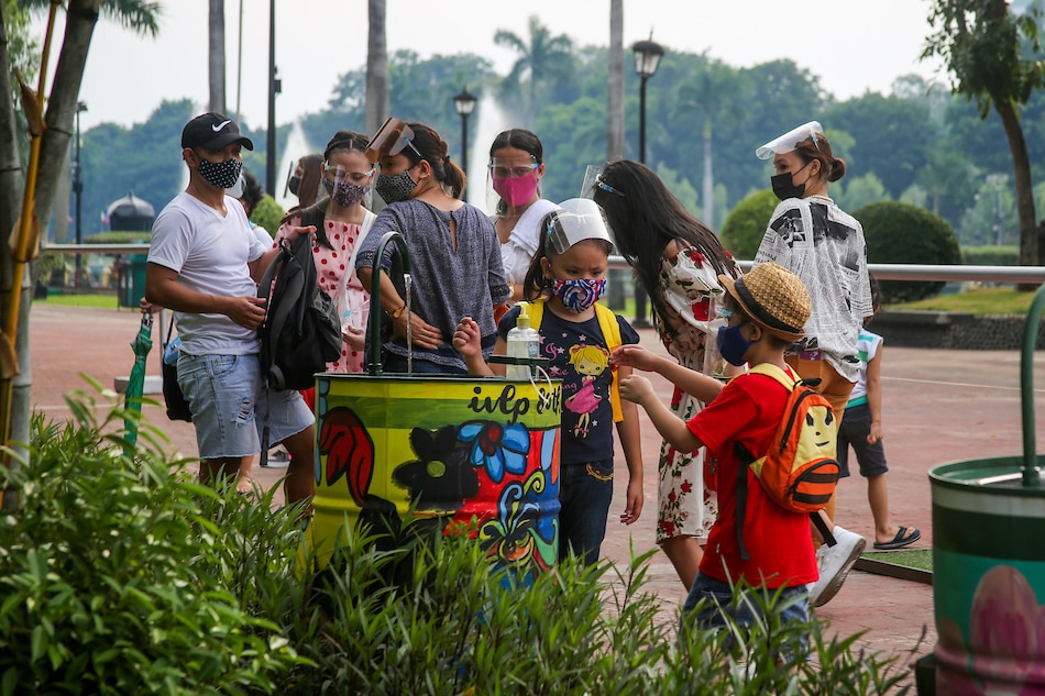 Parents spend time with their children in Rizal Park in Manila on July 15, 2021, days after the COVID-19 pandemic task force partially lifted stay-at-home orders for children aged 5 and up in areas under the two loosest quarantine levels. Jonathan Cellona, ABS-CBN News/File