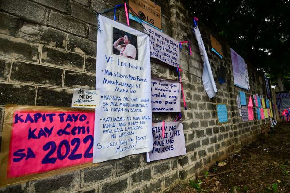 Ribbons and posters adorn the street around the vicinity of the Office of the Vice President in Quezon City on September 27, 2021, expressing support to Vice President Leni Robredo to run for president in the upcoming 2022 national elections. Mark Demayo, ABS-CBN News