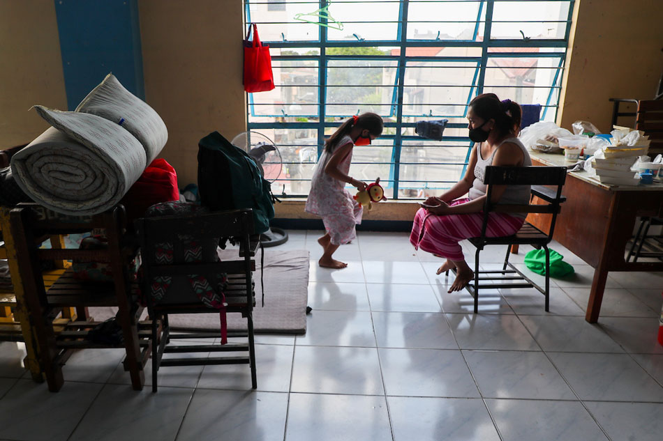  A mother talks to her daughter as they get ready to return home after spending time at the Sto. Niño High School reverse isolation facility in Marikina on April 14, 2021. The Marikina government has turned to “reverse isolation” where people who tested negative for the COVID-19 virus are removed from their households and placed in evacuation centers to decongest its quarantine facilities. Jonathan Cellona, ABS-CBN News