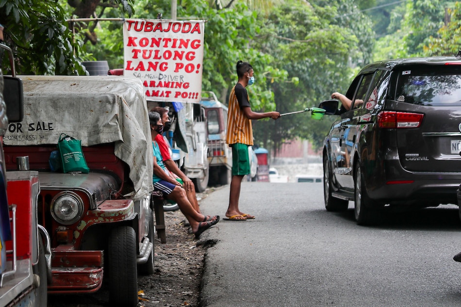 Jeepney drivers whose livelihood has been adversely affected by the pandemic ask for alms from passing motorists in Barangay Pansol, Balara in Quezon City on Aug. 17, 2021. Jonathan Cellona, ABS-CBN News/File