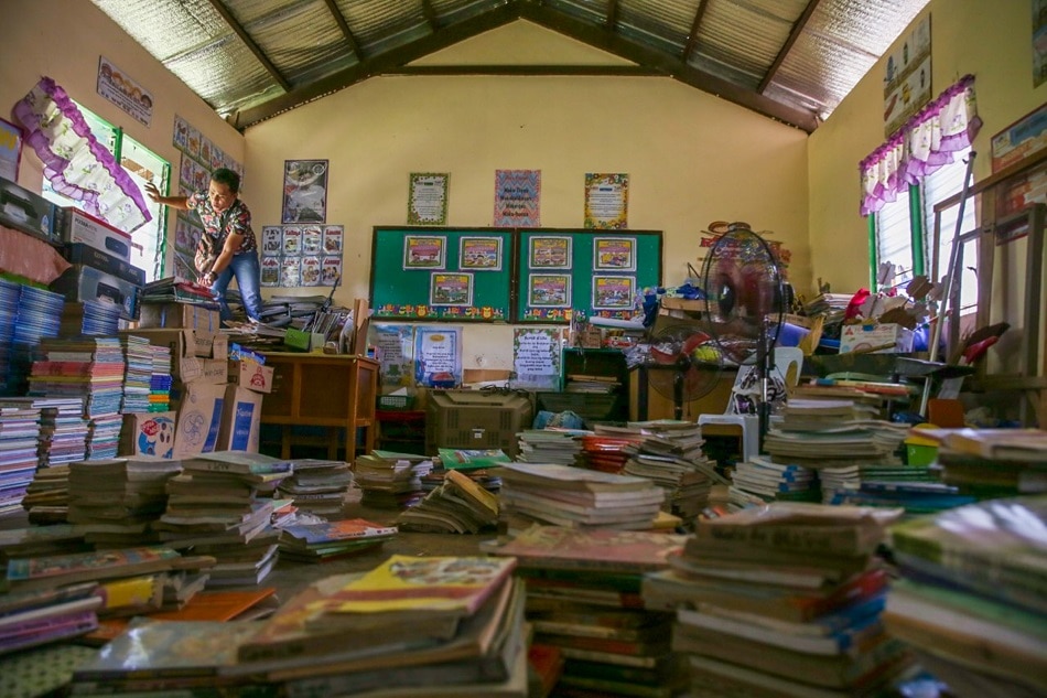 A teacher cleans a room at the Nabuclod Integrated School in Floridablanca, Pampanga on May 27, 2019. Jonathan. Cellona, ABS-CBN News/File