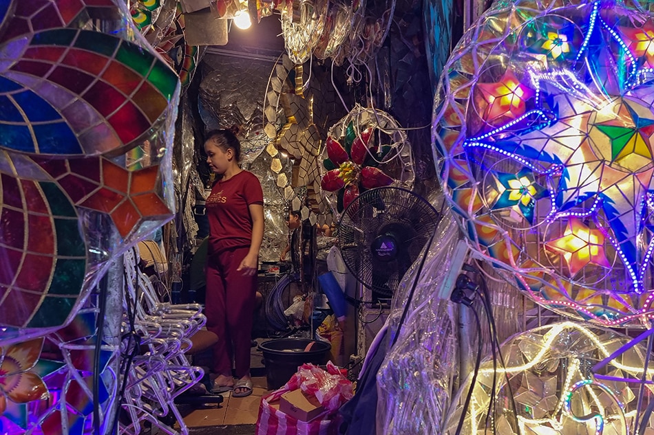 Store owner Sato Laxa and his family wait for customers at their lantern shop along Granada street in Barangay Valencia, Quezon City on Sept. 29, 2021. Gigie Cruz, ABS-CBN News/File 