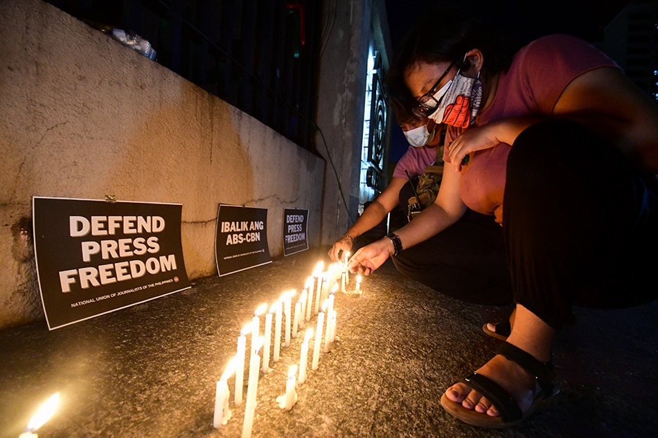 Press freedom advocates join ABS-CBN employees during a candle lighting event led by the National Union of Journalists of the Philippines, a year after ABS-CBN went off-air, outside its broadcasting center in Quezon City on May 5, 2021. Gigie Cruz, ABS-CBN News/file