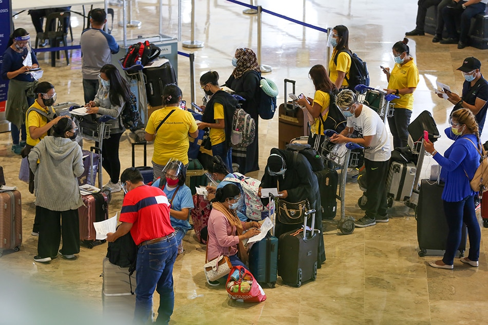 Overseas Filipino Workers queue at the departure area of the Ninoy Aquino International Airport Terminal 1 as they process their travel documents for their overseas trip on May 31, 2021. Jonathan Cellona, ABS-CBN News/File