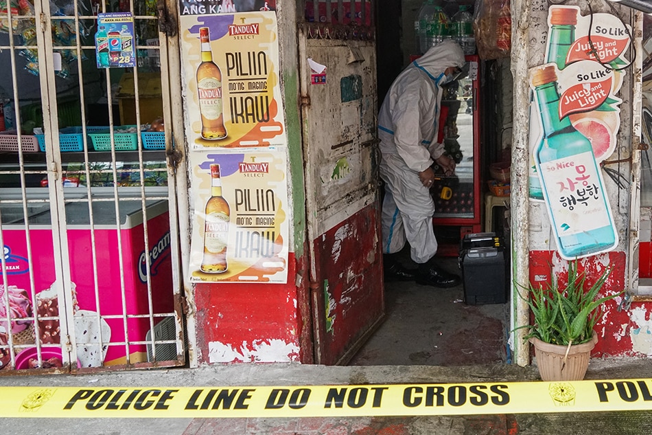 Crime scene investigators check a store in Singalong, Manila after its owner, Rodrigo Nuneza Arizo, was killed by 3 unknown assailants on Monday morning. Investigators at the Manila Police District Homicide Section are currently looking at the incident as a possible robbery with homicide case as an estimated amount of P120,000 cash and 2,000 worth of goods were discovered missing. Stringer 