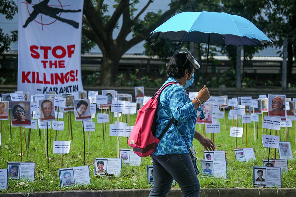 Members of human rights groups lay flowers on photos of victims of extrajudicial killings as part of activities leading up to International Human Rights Day at the Bantayog ng mga Bayani in Quezon City on Dec. 1, 2020. Jonathan Cellona, ABS-CBN News/File 