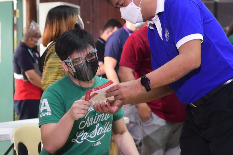 UAAP student-athletes receive their first dose of COVID-19 vaccines in a ceremonial vaccination event at the Commission on Higher Education in Quezon City on October 20, 2021, as part of the agency's vaccination drive of students. Mark Demayo, ABS-CBN News