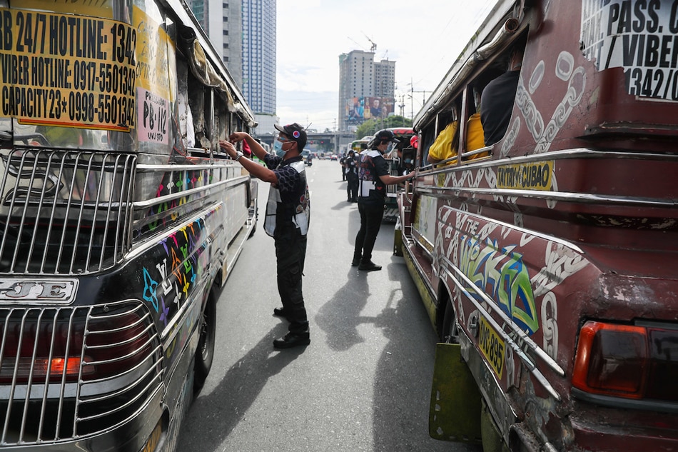 Members of the Inter-Agency Council for Traffic (I-ACT) Special Task Force inspect passing public utility vehicles along Katipunan Avenue in Quezon City on May 10, 2021. Jonathan Cellona, ABS-CBN News/File 