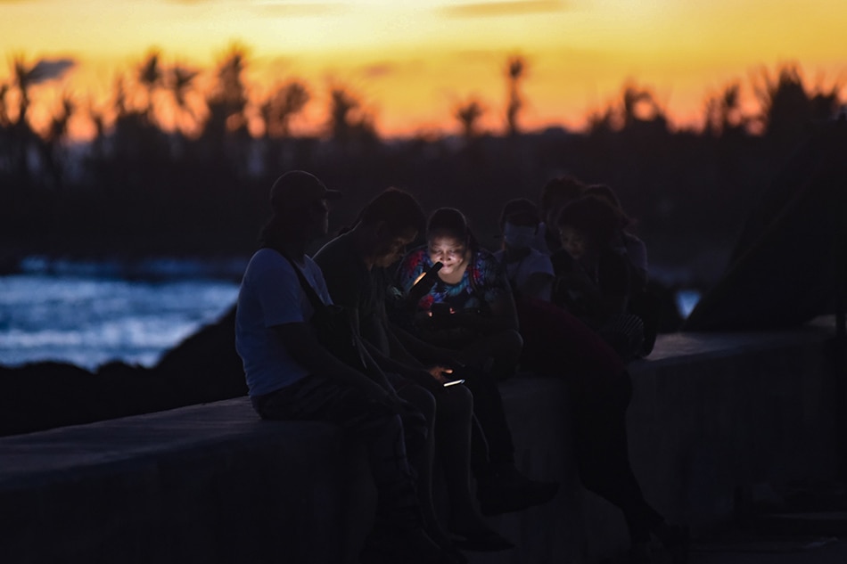 Residents while away by the shore to catch a phone signal in Virac, Catanduanes on November 13, 2020. George Calvelo, ABS-CBN News/File