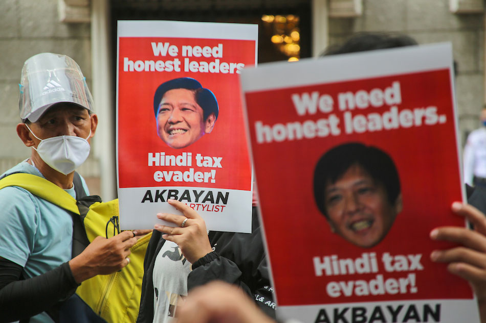 An activist holds a sign during a protest in commemoration of the anniversary of the 1972 Martial Law in Manila on September 21, 2021. Various groups marked the 49th anniversary of the declaration of martial law by the late Philippine dictator Ferdinand Marcos with an outcry against the present government which they say has authoritarian tendencies and has committed human rights violations. Basilio H. Sepe, ABS-CBN News