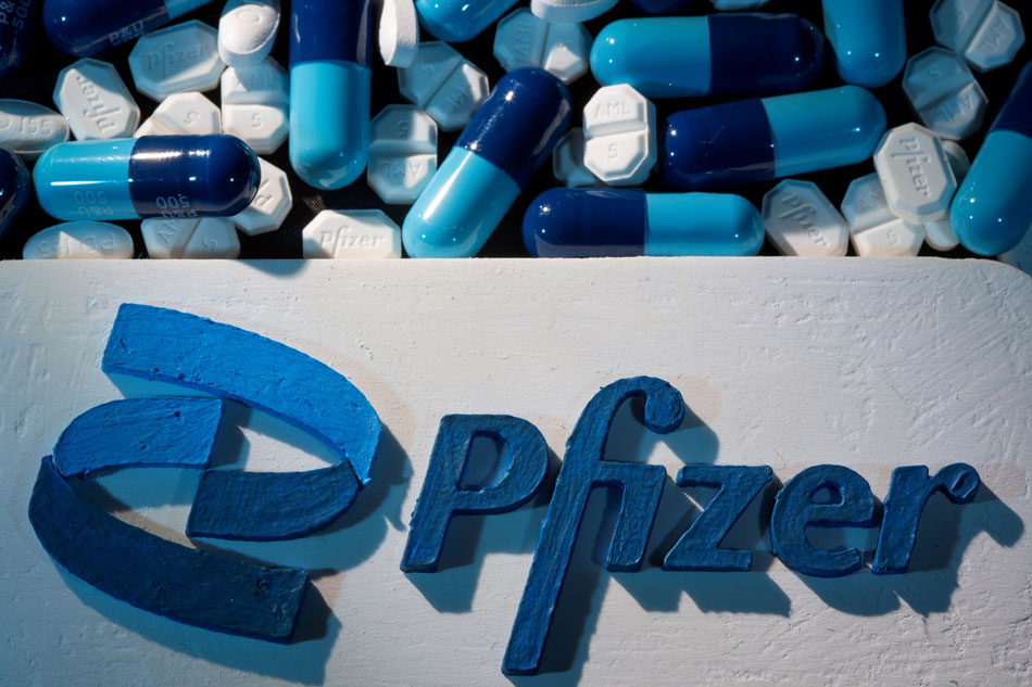 A 3D printed Pfizer logo is placed near medicines from the same manufacturer in this illustration taken September 29, 2021. Dado Ruvic, Reuters/File Photo