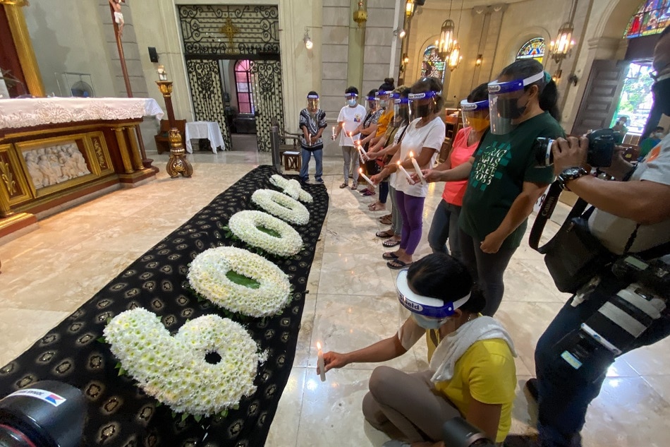 Climate advocates light candles as they mark the 8th anniversary of Typhoon Yolanda at the Our Lady of Remedies Parish in Malate, Manila on November 8, 2021. The group paid tribute to the more than 6,000 lives lost during the deadly Category 5 typhoon that hit the central regions of the country in 2013. Jonathan Cellona, ABS-CBN News