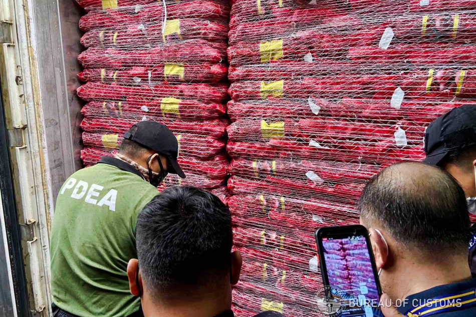 A total of 18 container vans containing smuggled red onions were discovered during a spot check inspection at the Mindanao Container Terminal Sub-Port in Misamis Oriental. Photo courtesy of the Bureau of Customs