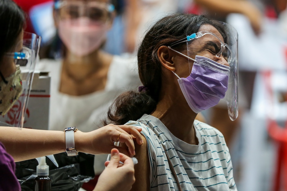 San Juan residents are inoculated against COVID-19 with the Pfizer vaccine at the Filoil Flying V Center in San Juan City on Nov. 9, 2021. Jonathan Cellona, ABS-CBN News