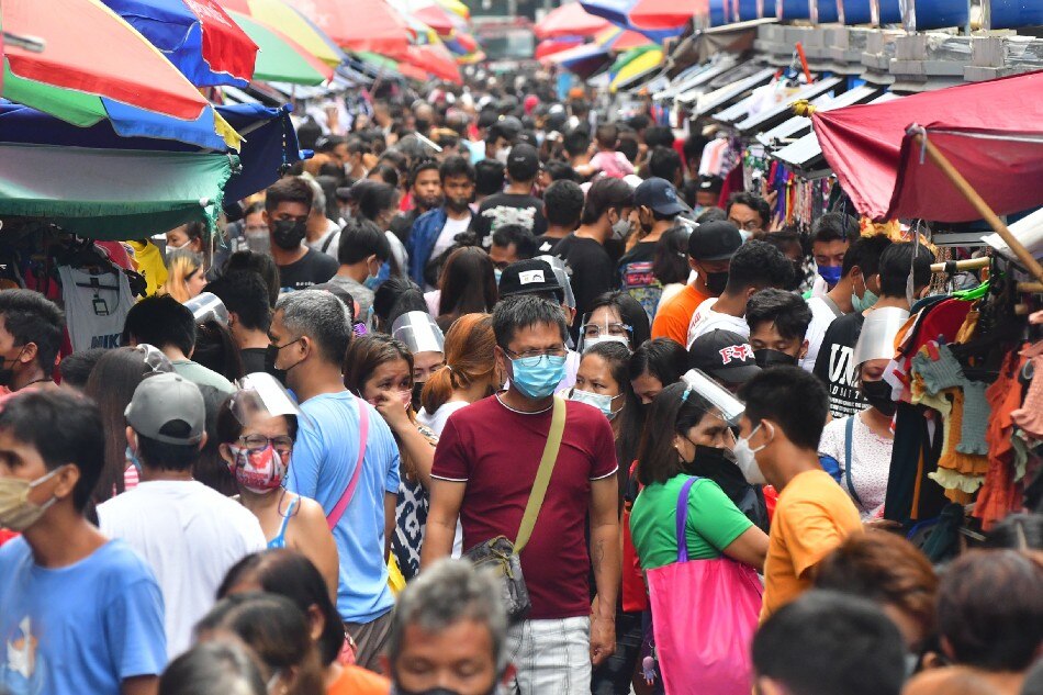 Shoppers go around the Divisoria market in Manila on Sunday, November 14, 2021. 