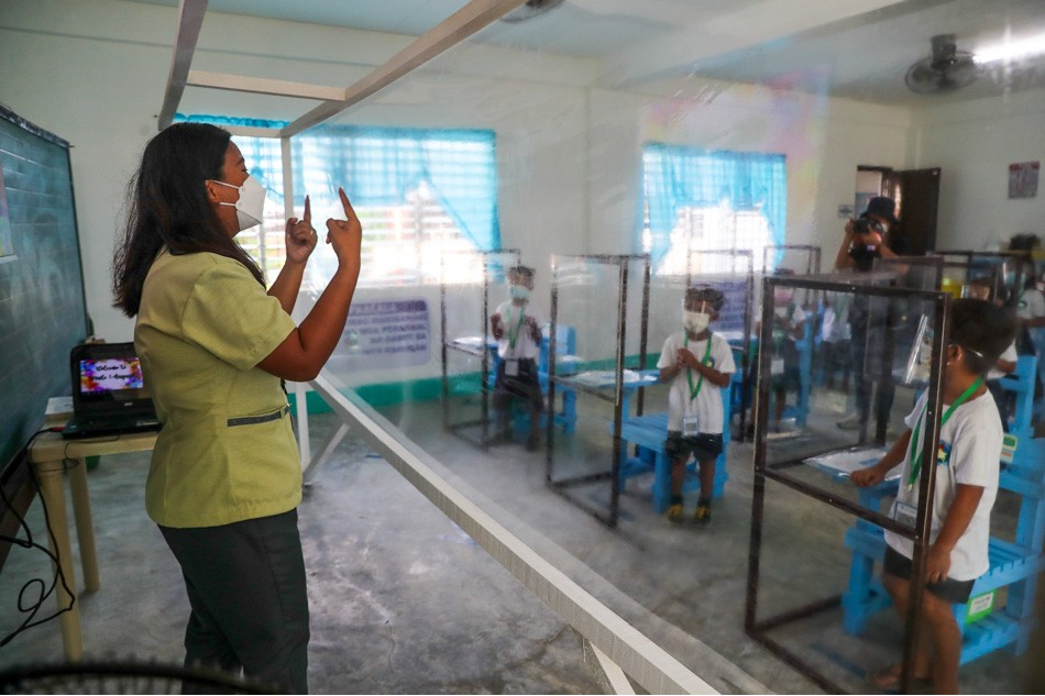 Pupils observe minimum health protocols as they attend the first day of limited face to face classes at the Longos Elementary School in Barangay Pangapisan in Alaminos City, Pangasinan on November 15, 2021.  Jonathan Cellona, ABS-CBN News