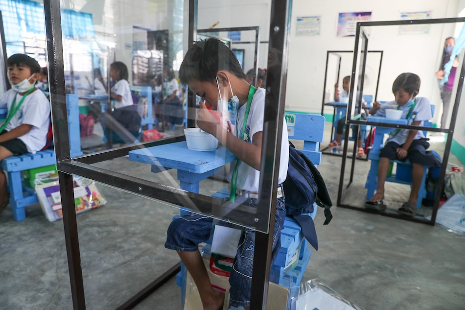 Pupils observe minimum health protocols as they attend the first day of limited face-to-face classes at the Longos Elementary School in Barangay Pangapisan in Alaminos City, Pangasinan on November 15, 2021. Jonathan Cellona, ABS-CBN News