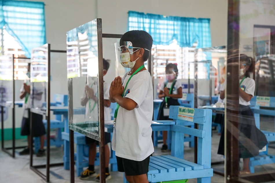 Pupils observe minimum health protocols as they attend the first day of limited face-to-face classes at the Longos Elementary School in Barangay Pangapisan in Alaminos City, Pangasinan on Monday. Jonathan Cellona, ABS-CBN News