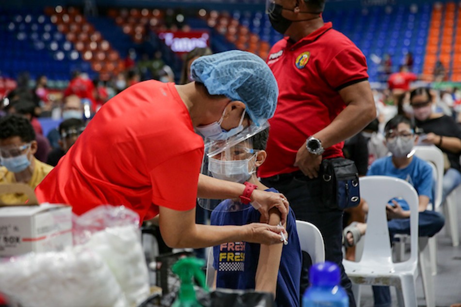 Parents accompany their children as San Juan City launches its vaccination program for their pediatric residents at the Filoil Flying V Arena on Nov. 3, 2021. George Calvelo, ABS-CBN News/File