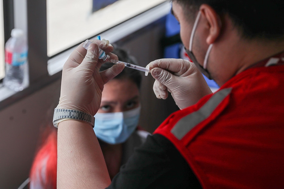 Students of University of the East receive their first dose of Astra Zeneca COVID-19 vaccine at the Bakuna Bus (Vaccine Bus) by the Philippine Red Cross (PRC) in Manila on November 18, 2021. Jonathan Cellona, ABS-CBN News/File