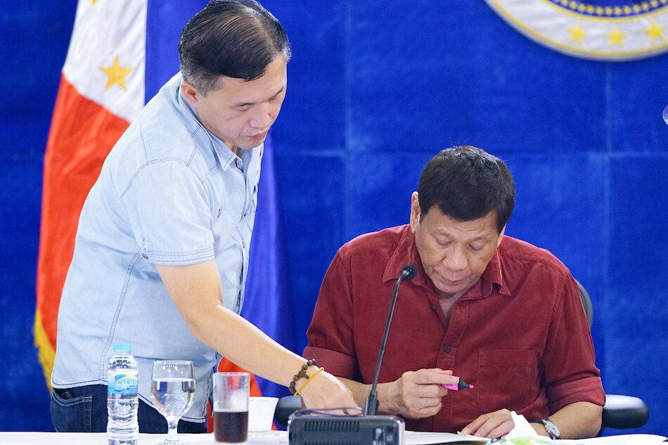 President Rodrigo Duterte is assisted by Sen. Christopher 