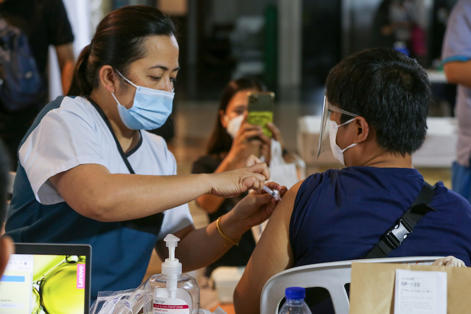 People get their vaccines at the Ospital ng Maynila during the roll-out of the National Vaccination Days on November 29, 2021 in Manila. Jonathan Cellona, ABS-CBN News