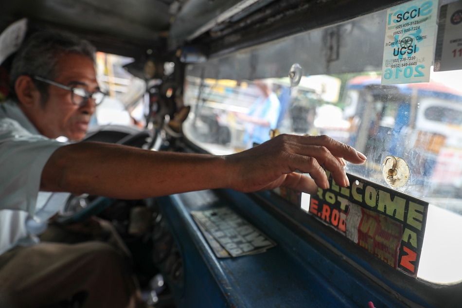 A jeepney driver plies his route with signboards on his dashboard. Jonathan Cellona, ABS-CBN News