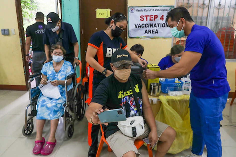 Elderly residents and those with comorbidities line up to receive their COVID-19 vaccine at the Sta. Ana Elementary school in Manila during the National Vaccine Day on Dec. 1, 2021. Jonathan Cellona, ABS-CBN News