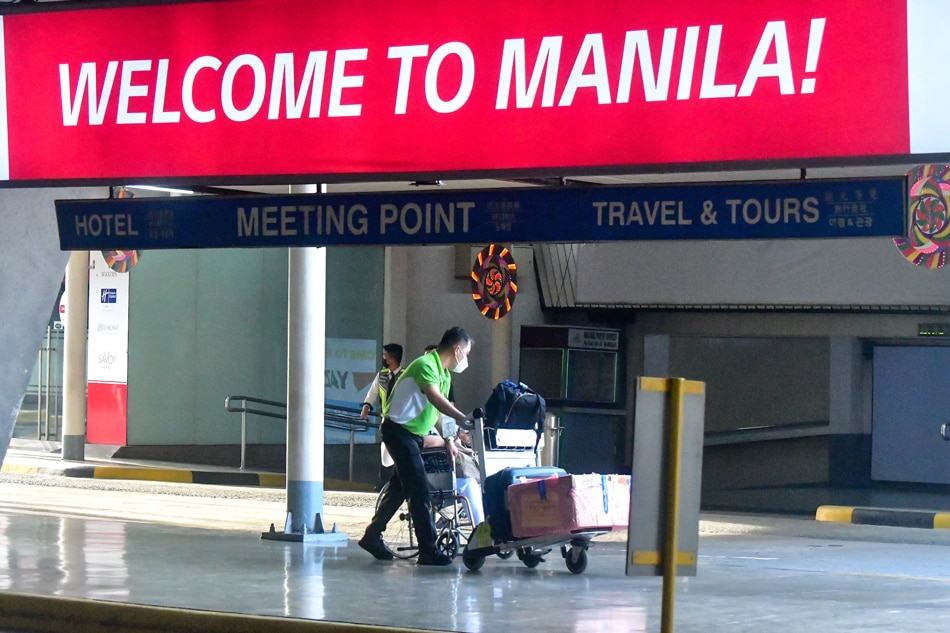 Passengers arrive at the NAIA Terminal 1 on November 29, 2021 amid the IATF ban on 14 countries affected by the Omicron variant of the coronavirus. The DFA said dozens of Filipinos are stranded in those regions following the ban. Mark Demayo, ABS-CBN News