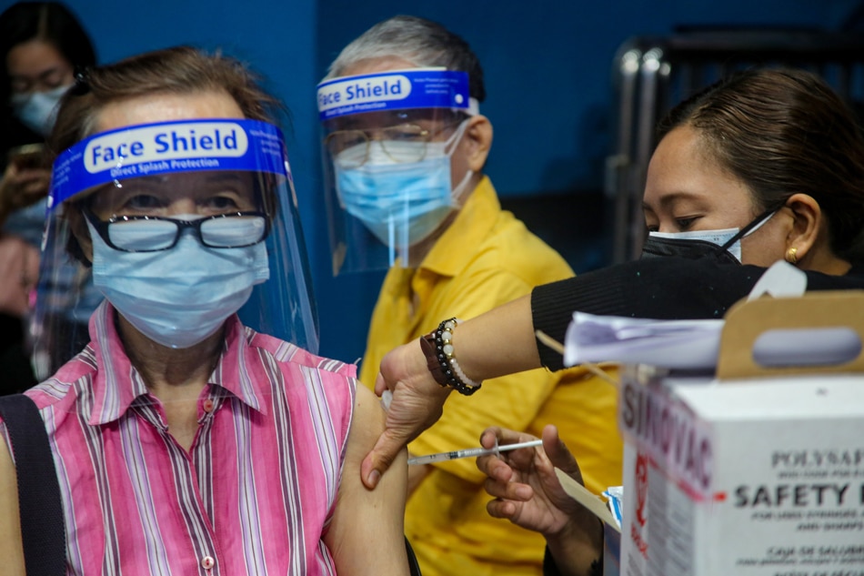 Senior citizens receive their COVID-19 vaccine booster shots at the Filoil San Juan Arena in San Juan City on Dec. 3, 2021. Jonathan Cellona, ABS-CBN News 