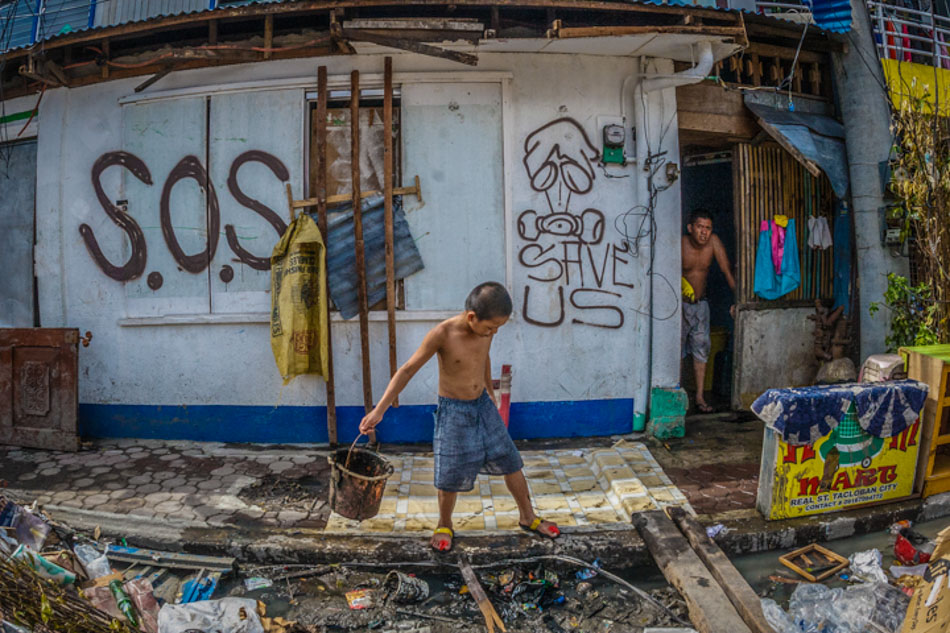 A boy searches through debris brought by the super typhoon Haiyan on 08 November 2013. Photo by Luis Liwanag