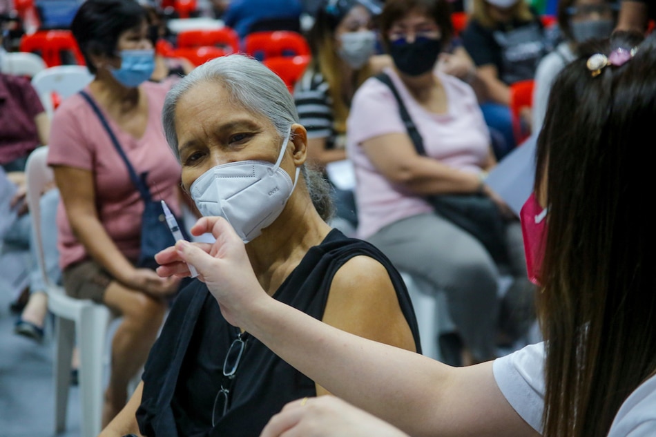 Senior citizens receive their COVID-19 vaccine booster shots at the Filoil San Juan Arena in San Juan City on Dec. 3, 2021. Jonathan Cellona, ABS-CBN News/File 