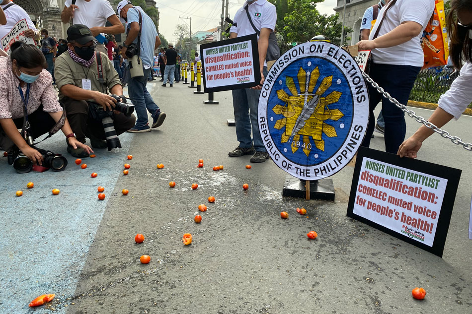 Members and supporters of Nurses United party-list picket outside Comelec to denounce their disqualification from the Halalan 2022 race. Jauhn Etienne Villaruel, ABS-CBN News