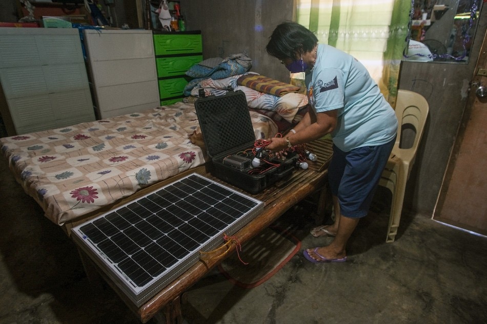 Lorna dela Pena takes out her TekPak solar-powered generator at her home in Marabut. Geela Garcia, Thomson Reuters Foundation