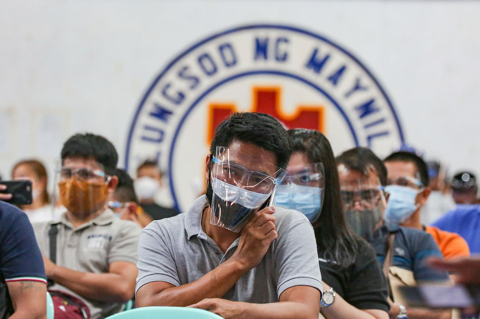 Seafarers line up to receive their second dose of the Pfizer COVID-19 vaccine inside the San Andres Sports Complex in Manila on July 8, 2021. George Calvelo, ABS-CBN News/File 