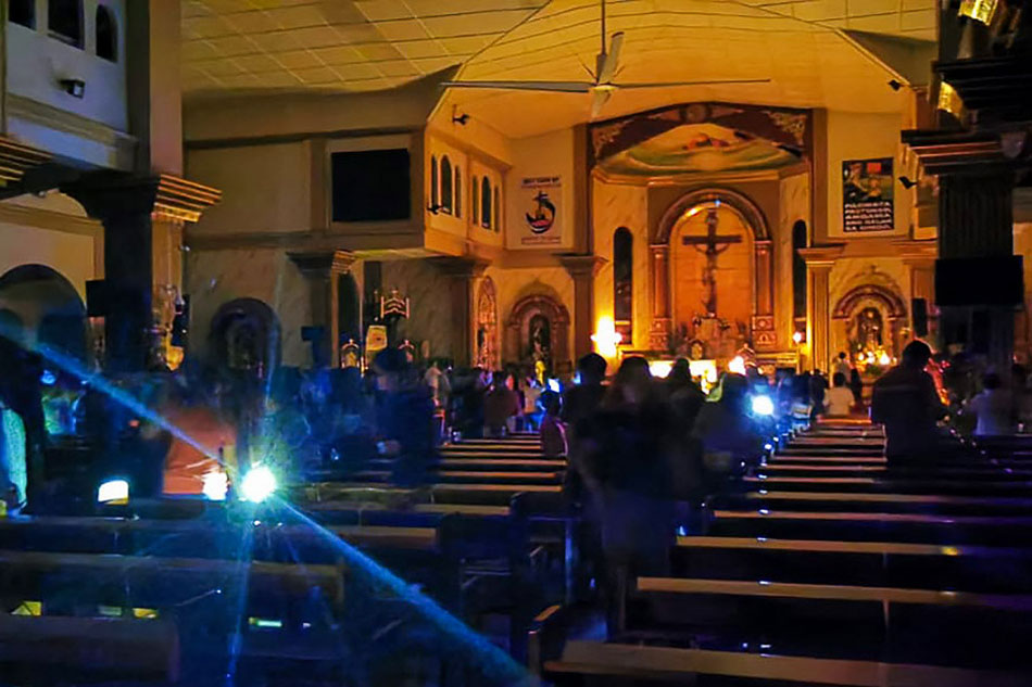 Residents attend a dawn mass without power at a church in Surigao City, Surigao del Norte on Saturday, after super-typhoon Odette passed over the city. Ferdinandh Cabrera, AFP