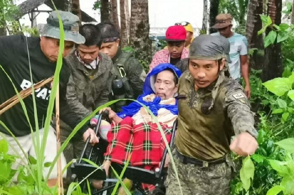 Soldiers help a man during amid rains caused by Odette. Courtesy of 4th Infantry Division