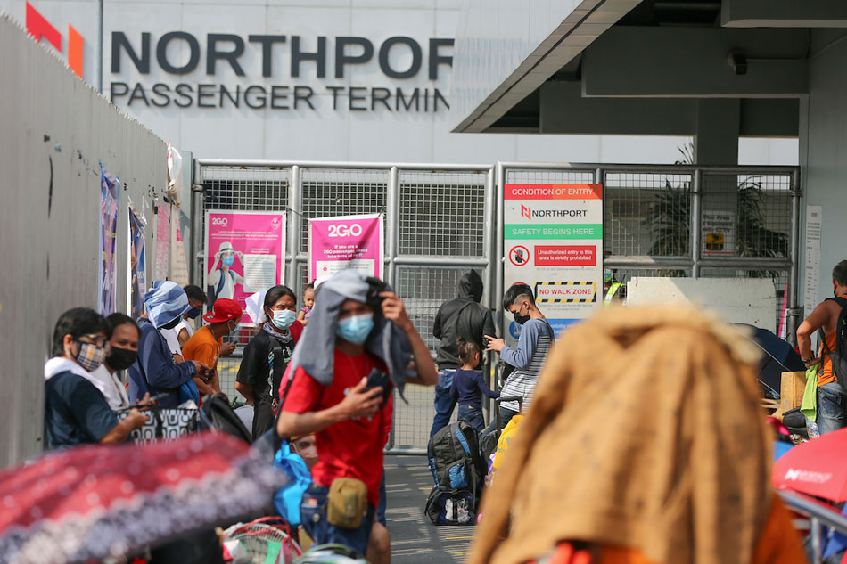 Travelers wait at the entrance of the North Port Passenger Terminal in Manila on December 23, 2021, to board the ships for various provinces in time for the holidays. Jonathan Cellona, ABS-CBN News