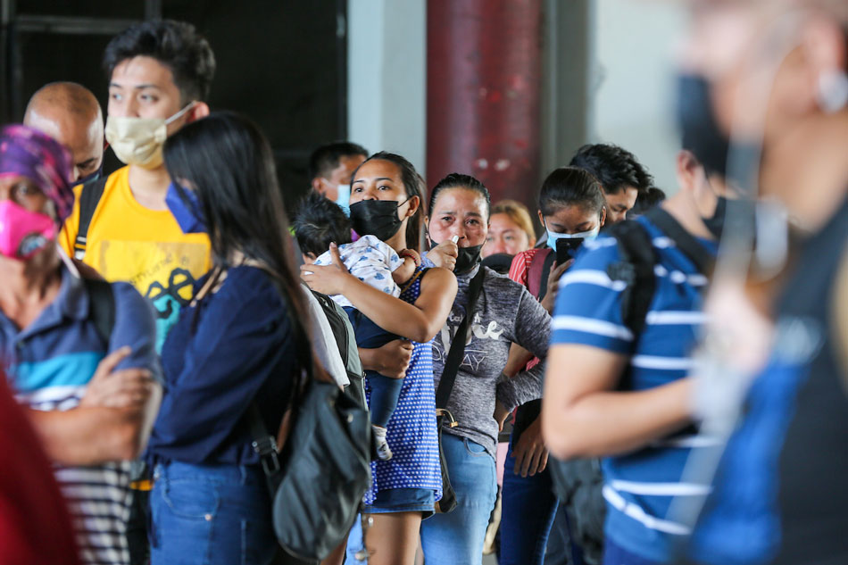 Travelers flock to bus terminals as they line up to take their bus rides in Cubao Quezon City on December 31, 2021, hoping to reach their respective provinces in time to welcome the New Year. Jonathan Cellona, ABS-CBN News