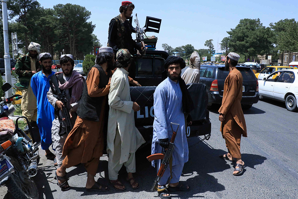 Taliban forces patrol a street in Herat