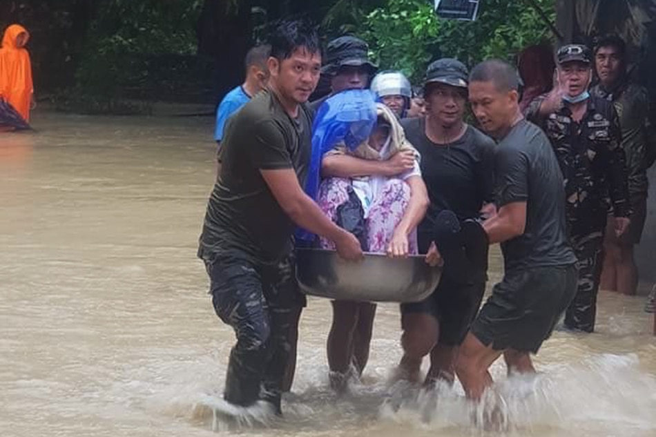 Members of the Philippine Army, Philippine National Police and the Odiongan Romblon Disaster Risk Reduction Management Office evacuate residents as flood waters rise due to heavy rains brought by Tropical Storm Dante on June 2, 2021. PIA Romblon
