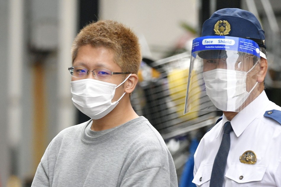 Kyota Hattori, 24, who was arrested on suspicion of a knife, arson and acid attack incident on the Keio Line train on Halloween day on October 31, 2021, is escorted to the prosecutor