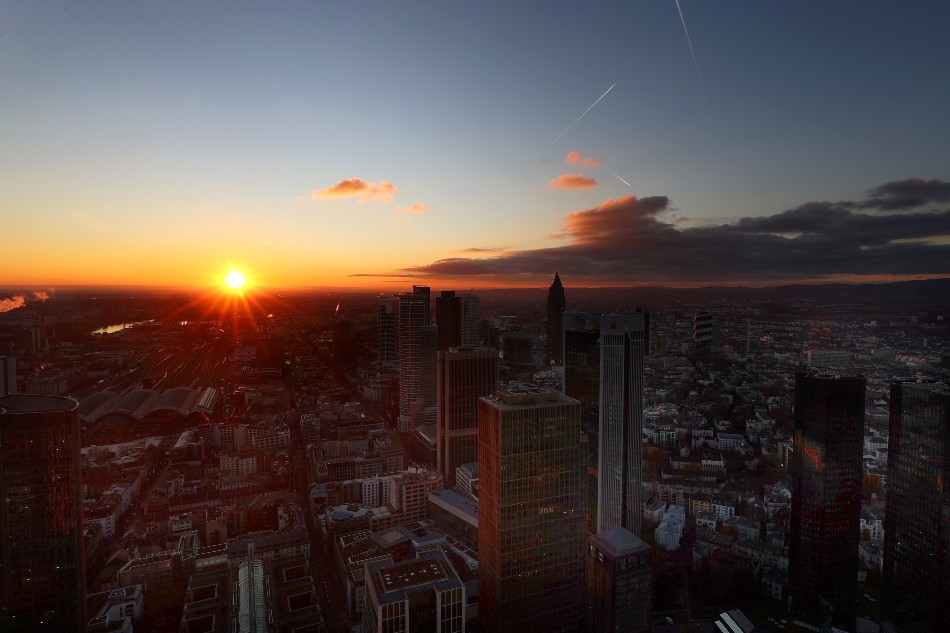 The sun sets after the first day with Germany's new COVID-19 rules at workspaces and in public transport as the spread of COVID-19 continues in Frankfurt, Germany, November 24, 2021. A person suspected to have the Omicron variant arrived in Germany through the Frankfurt international airport. Kai Pfaffenbach, Reuters/file