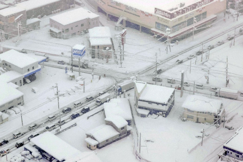 An aerial view shows vehicles stranded in the snow along the route 8 and 528 in Hikone, Shiga prefecture, Japan December 27, 2021, in this photo taken by Kyodo. Kyodo/via Reuters