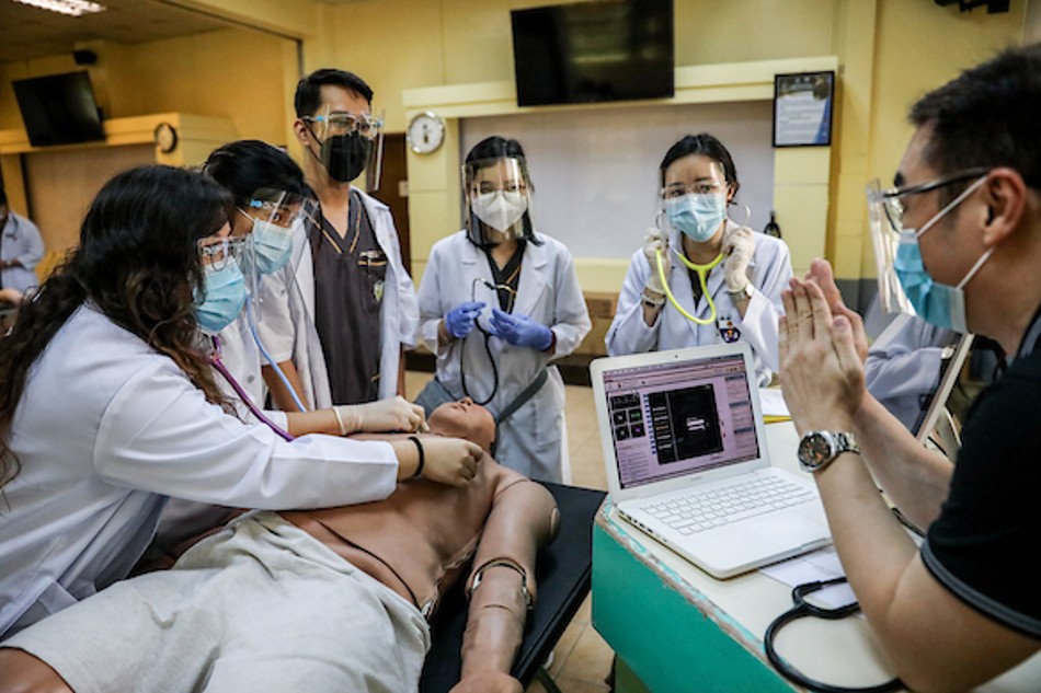 Medical students perform a clinical skills exercise on an electronic dummy during a face-to-face class at the University of Santo Tomas in Manila, June 10, 2021. Basilio H. Sepe, ABS-CBN News